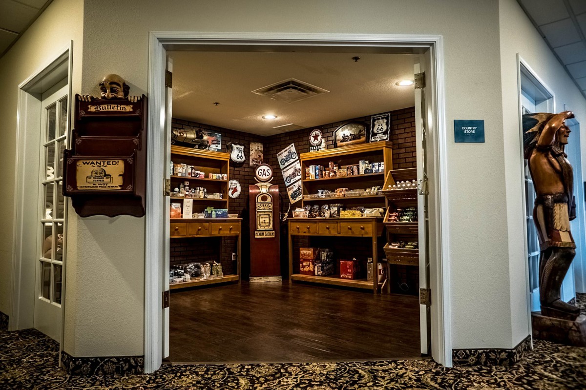 A cozy store interior with wooden shelves filled with various products.