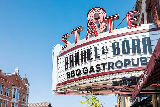 The iconic marquee of Barrel & Bone BBQ Gastropub under a clear blue sky.