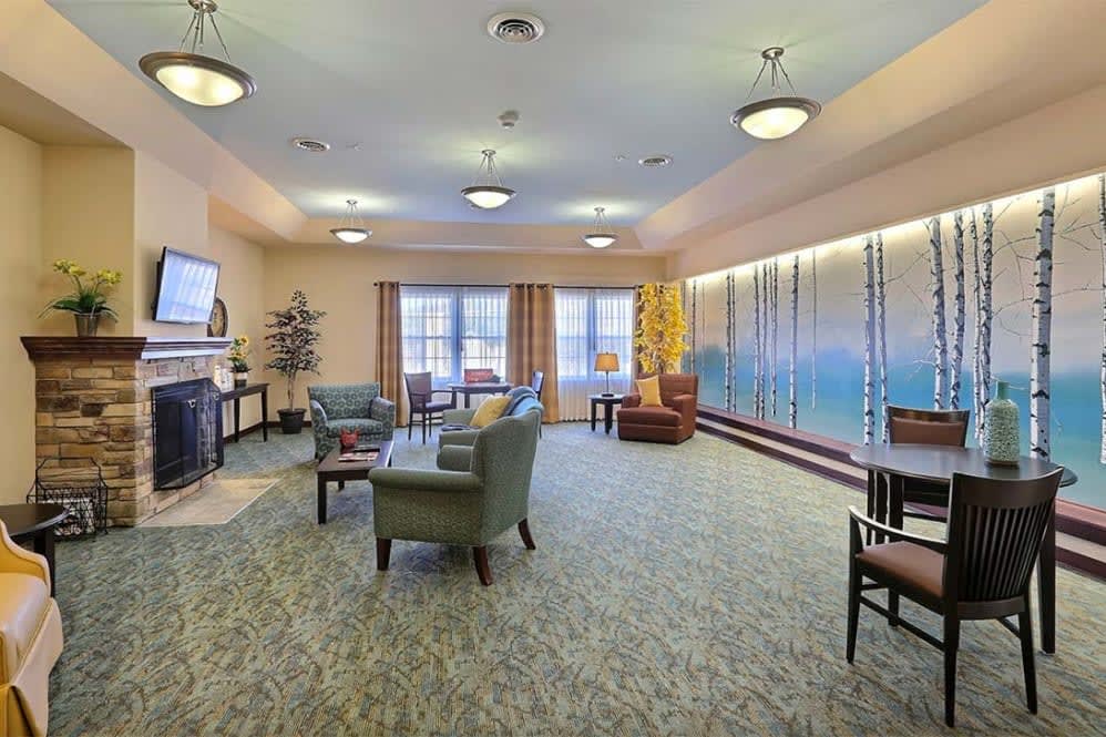 A spacious and well-decorated living room with comfortable seating and ambient lighting.