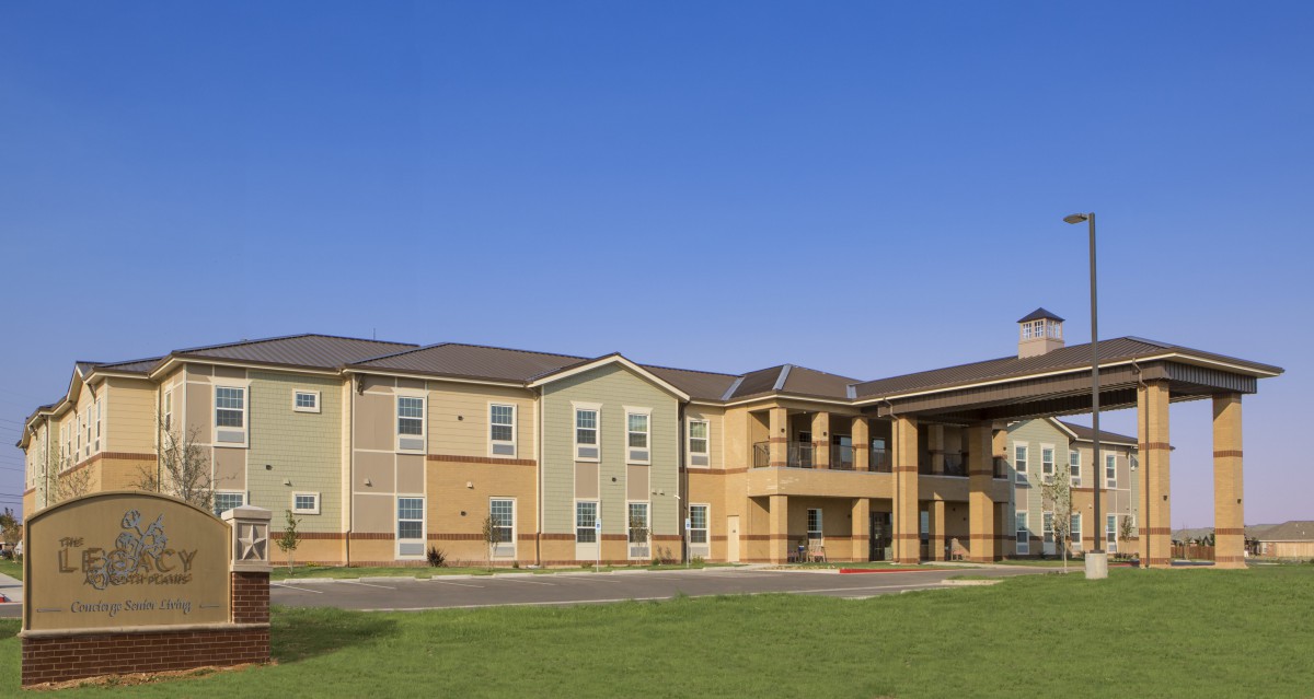 A modern residential apartment building with a clear blue sky background.