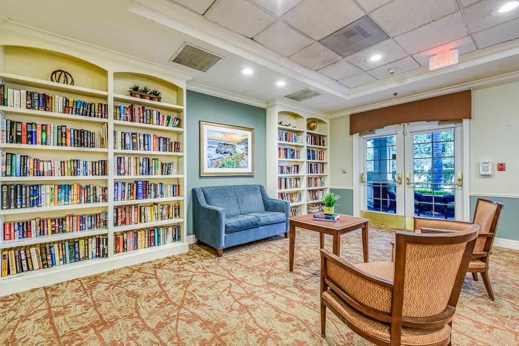 A cozy library with bookshelves and comfortable seating.