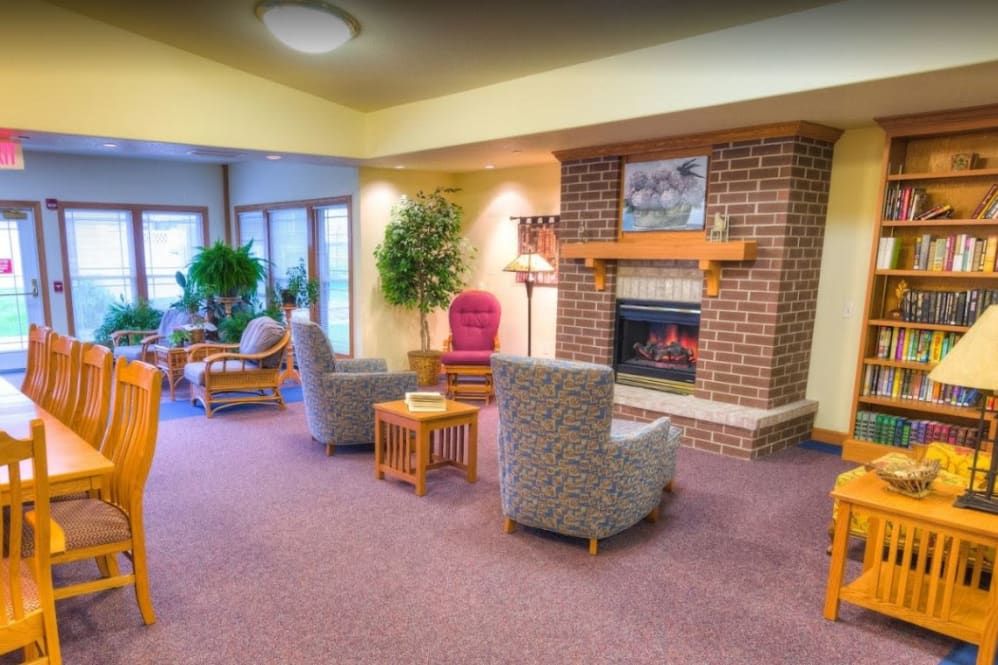 A cozy living room with comfortable seating and a warm fireplace.