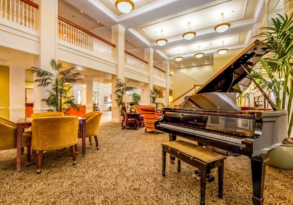 A luxurious lobby with elegant seating and a grand piano.
