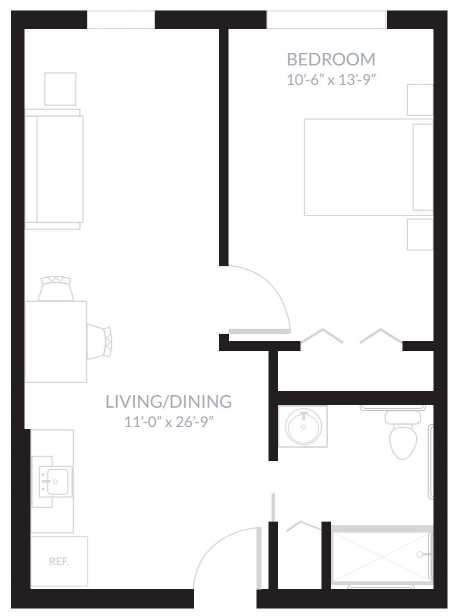 A floor plan of a one-bedroom apartment featuring a living/dining area, kitchen, and bathroom.