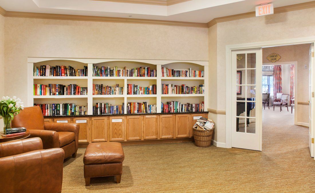 A cozy library corner with bookshelves and comfortable seating.