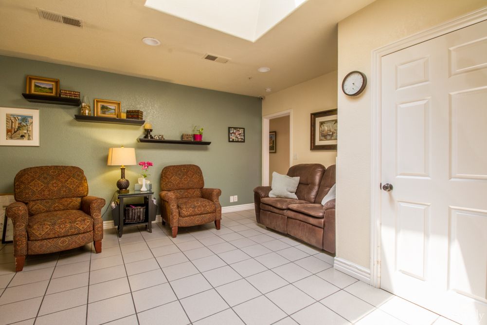 A cozy living room with leather furniture and decorative elements.