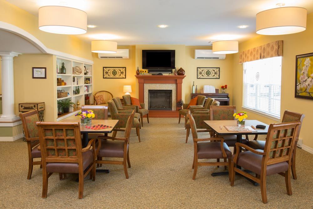 A cozy living room with a fireplace, television, and comfortable seating arrangements.