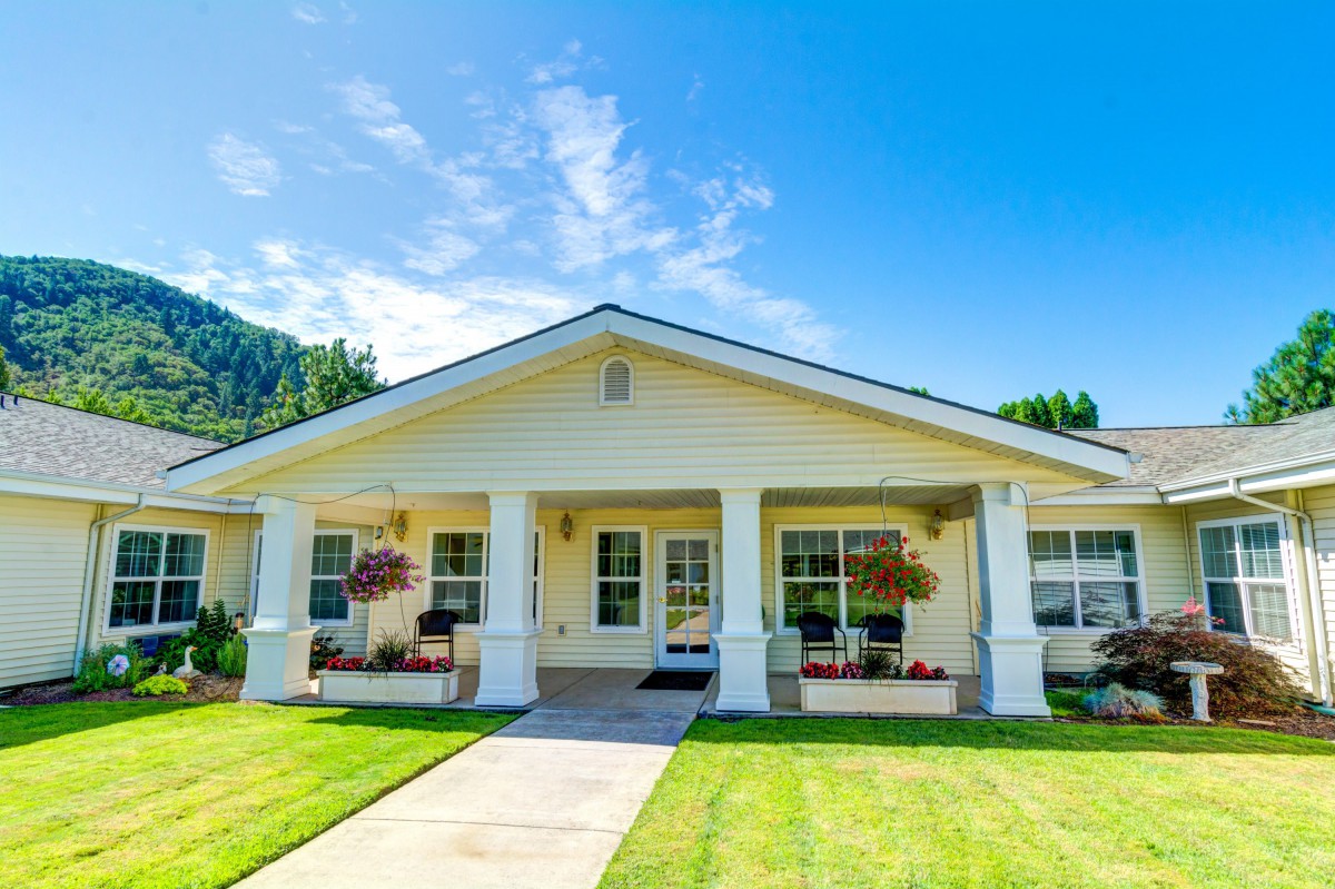 A suburban house with a well-maintained front yard and covered porch.