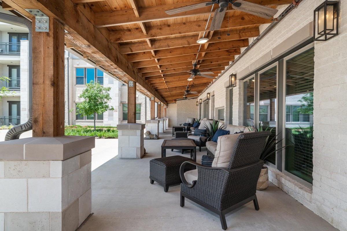 A spacious patio with comfortable seating and ceiling fans, offering a relaxing outdoor space.