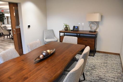 A modern dining room featuring a wooden table, stylish chairs, and elegant decor.
