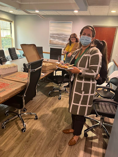 Team members enjoying a meal during a meeting.