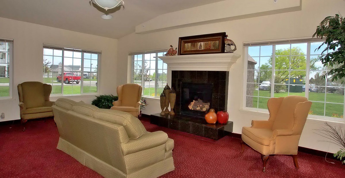 A cozy living room with a fireplace and comfortable seating.