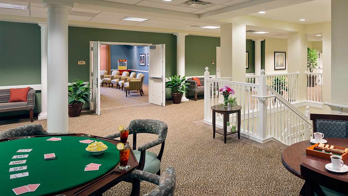 A cozy lounge area with comfortable seating and a card table.