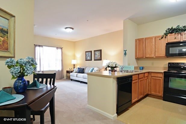 An open-layout apartment with a cozy living room and a kitchen area.