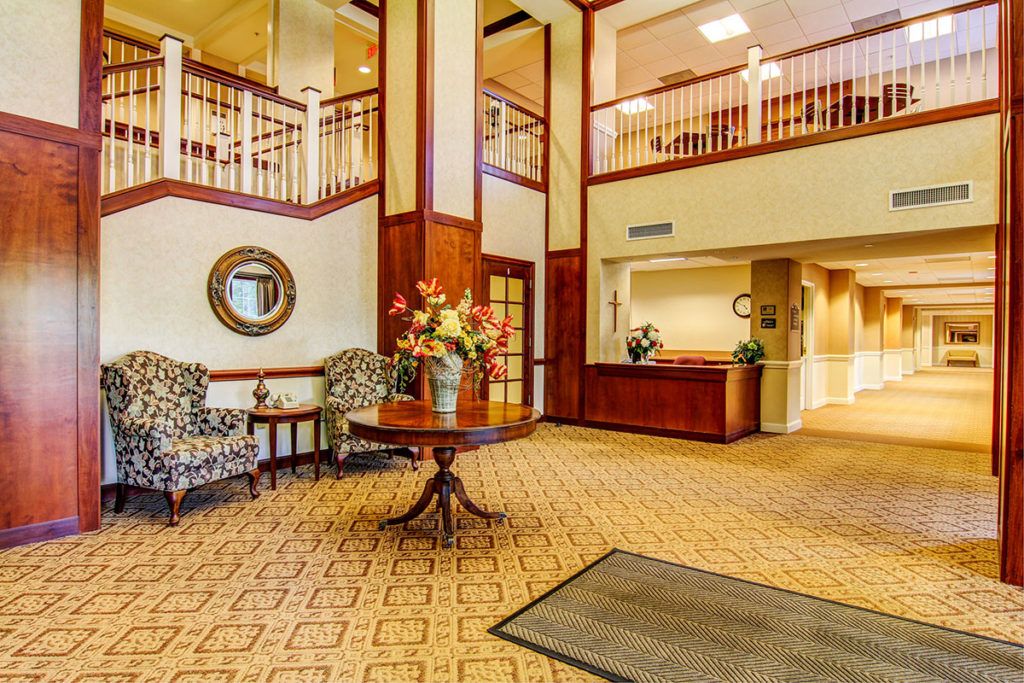 Spacious hotel lobby with elegant decor and a reception desk.