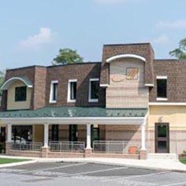 A modern commercial building showcasing a mix of brick and stucco design.