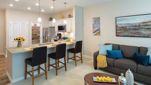 A stylish open-concept kitchen and living room featuring modern appliances and comfortable seating.