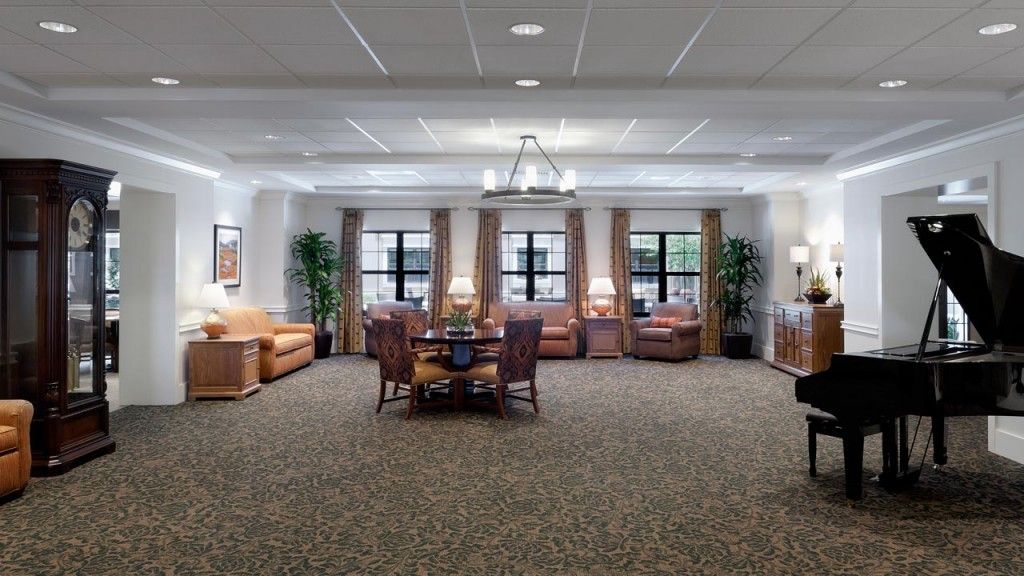 A spacious and well-lit living room with comfortable seating and elegant decor.