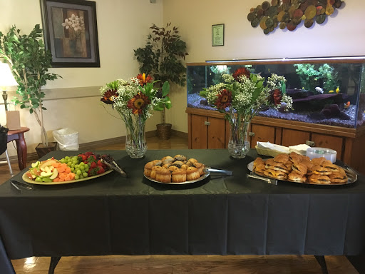 A beautifully arranged buffet featuring fresh salads and a selection of pastries, complemented by floral decorations.