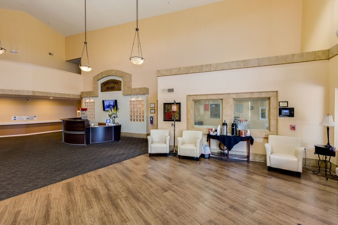 A spacious lobby area with comfortable seating and a reception desk.