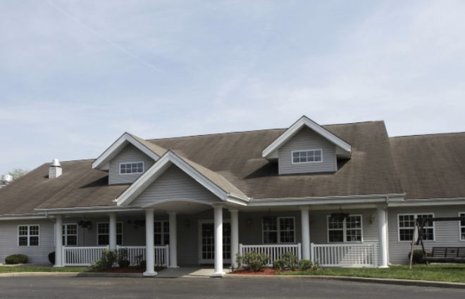 A single-story residential building with a covered porch and dormer windows.