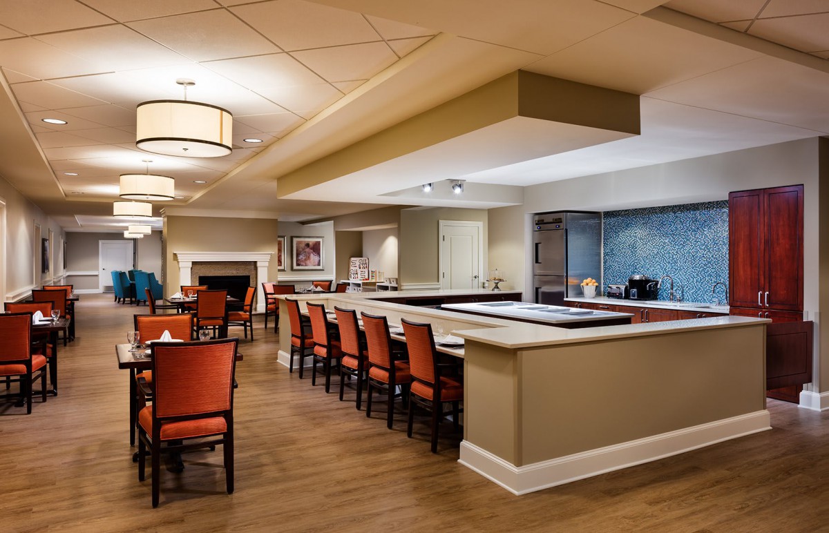 A modern dining and bar area with elegant seating and lighting.