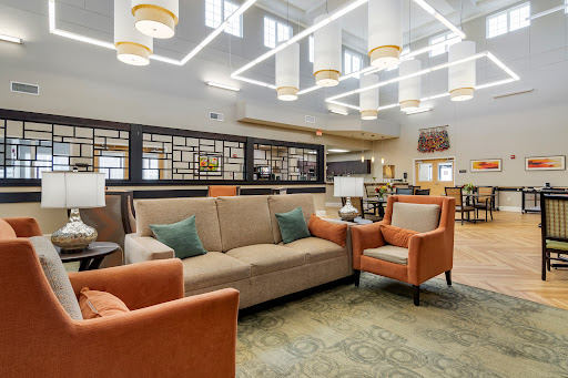 A contemporary lounge area featuring comfortable seating and modern lighting.