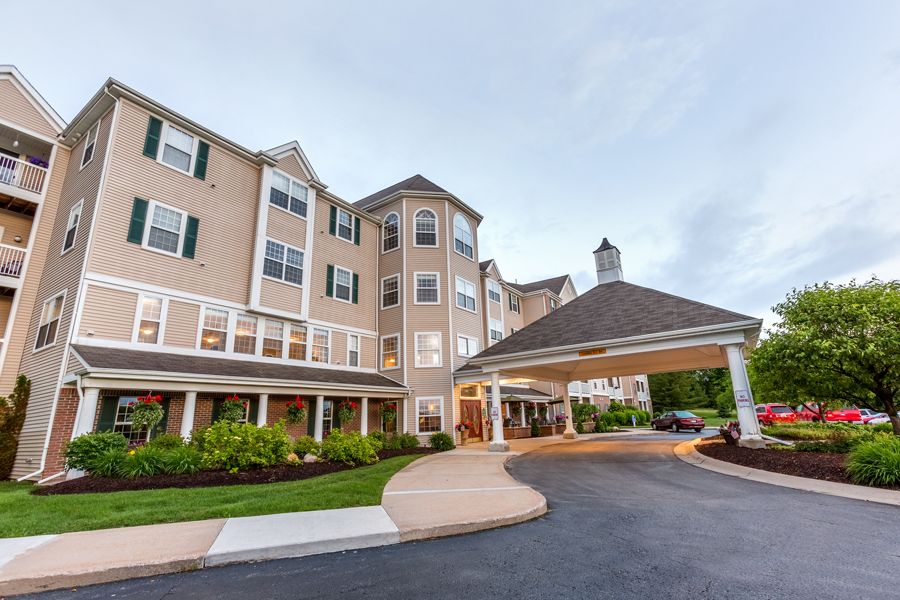 A modern residential building with a welcoming entrance and landscaped surroundings.