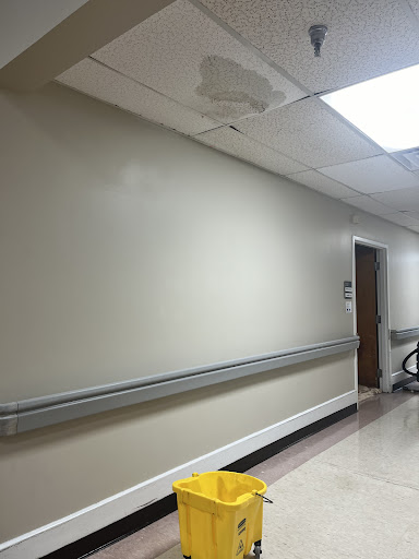 A view of a hospital hallway with clean walls and floors.