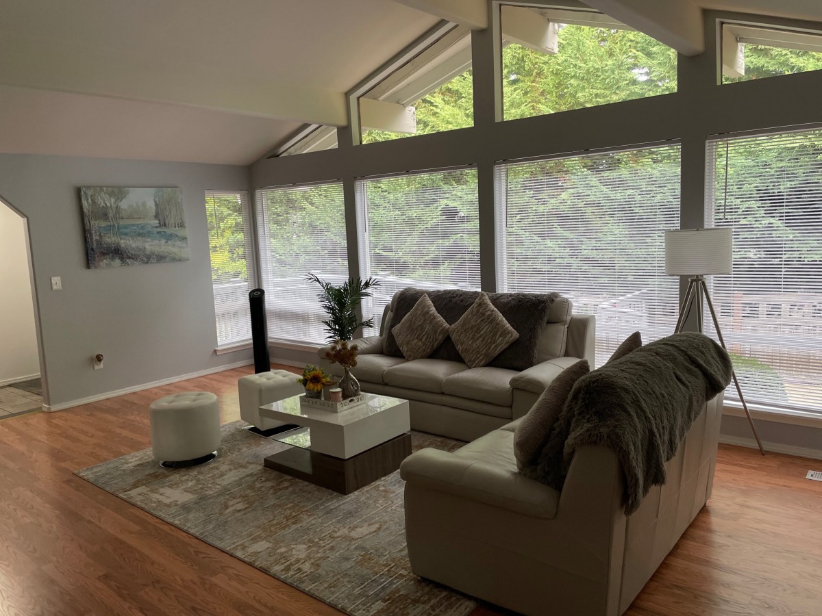 A modern living room with large windows letting in natural light.