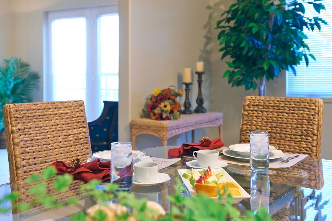 A beautifully set dining table with elegant place settings and decorative elements in a cozy dining room.