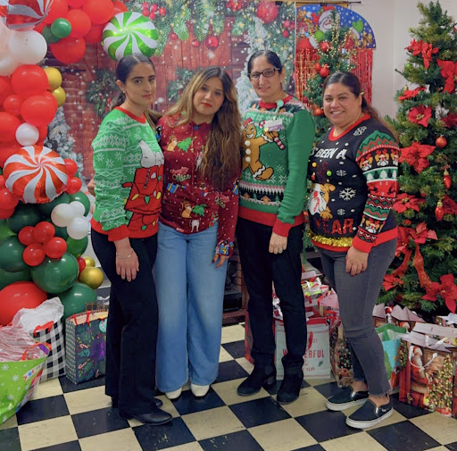 A festive group of friends celebrating the holiday season in their colorful Christmas sweaters.