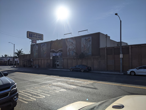 A commercial building in an urban setting captured under bright sunlight.
