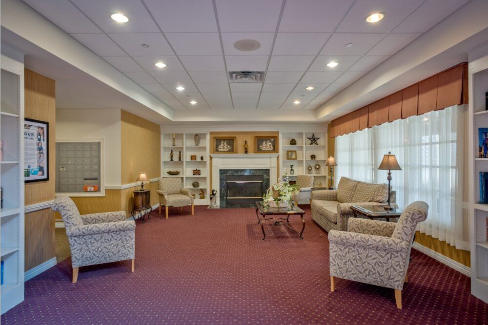 A cozy living room with sofas, a fireplace, and built-in bookshelves.