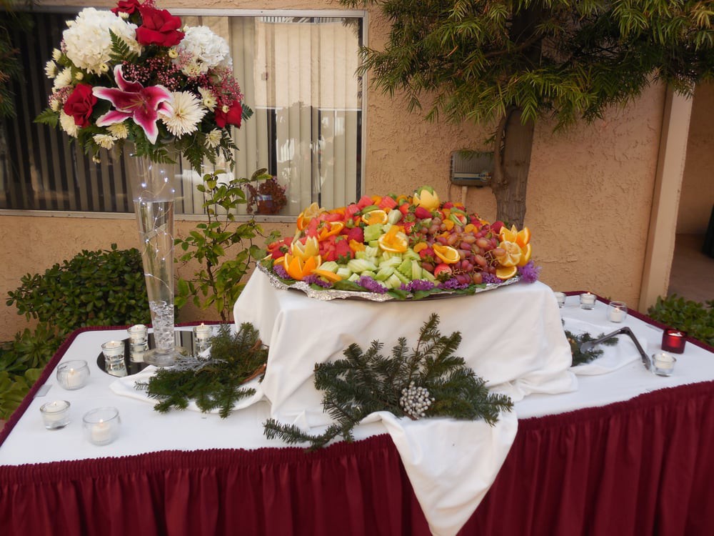 A beautifully arranged outdoor table adorned with colorful flowers and elegant decorations, perfect for a wedding or formal event.