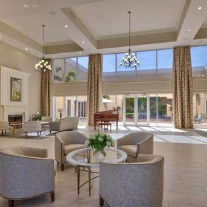 A spacious, modern lobby with ample seating and large windows allowing natural light to flood the space.