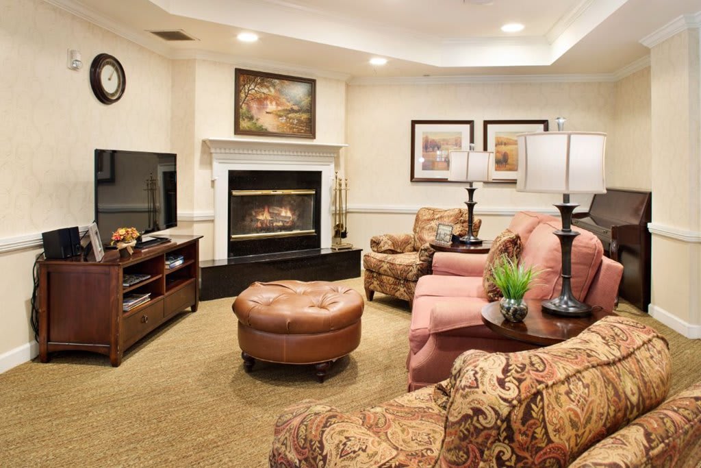 A cozy living room with a fireplace and comfortable seating arrangement.