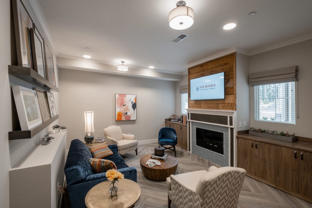 A modern, cozy living room with comfortable seating and a fireplace.