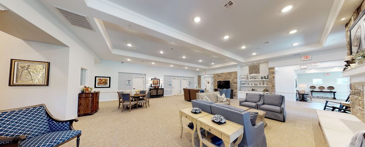 Spacious and modern living room with a cozy setup, featuring a comfortable sofa, dining table, and built-in shelving.