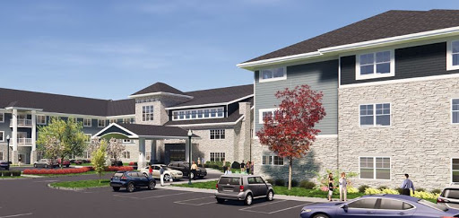 A modern residential building featuring attractive architecture and a well-maintained parking area.