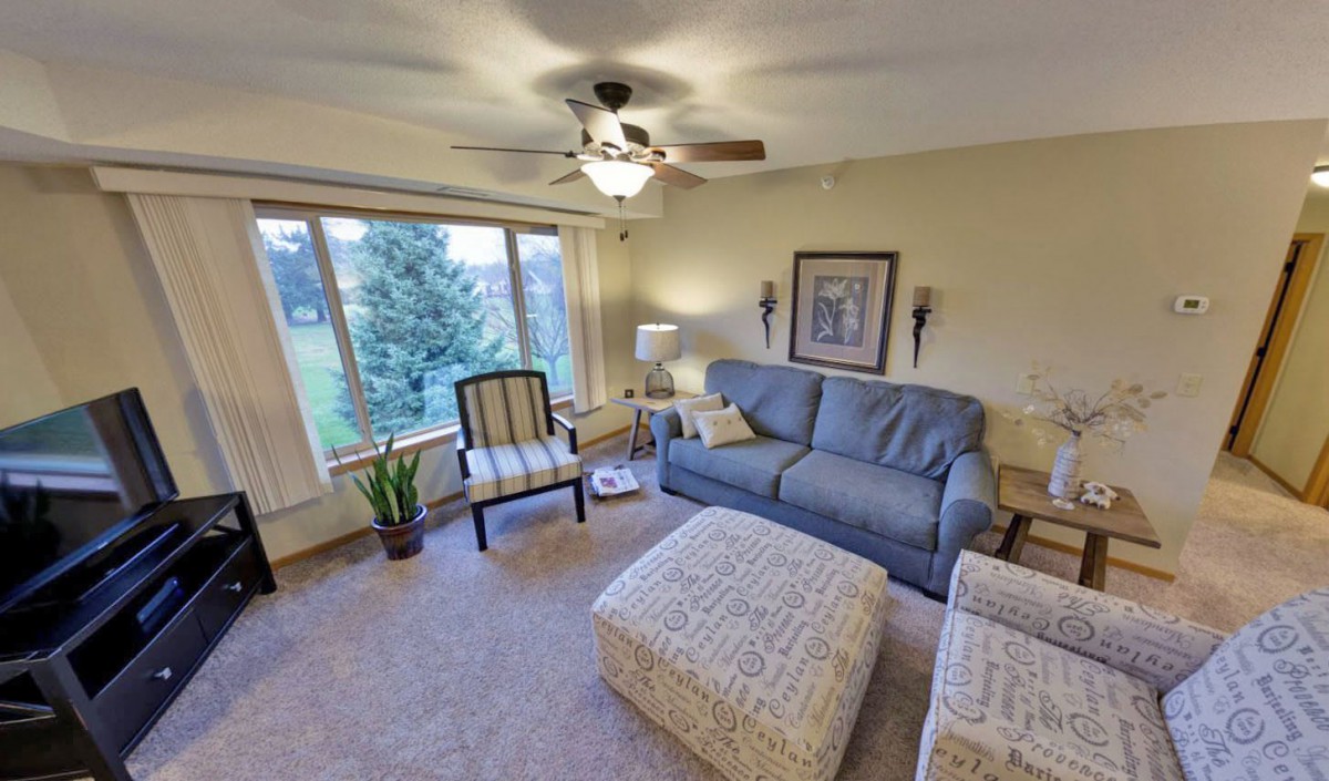 Cozy living room with comfortable seating and a scenic view through the window.