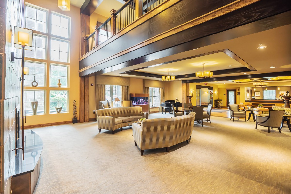 Spacious lounge with luxurious furnishings and wooden accents.