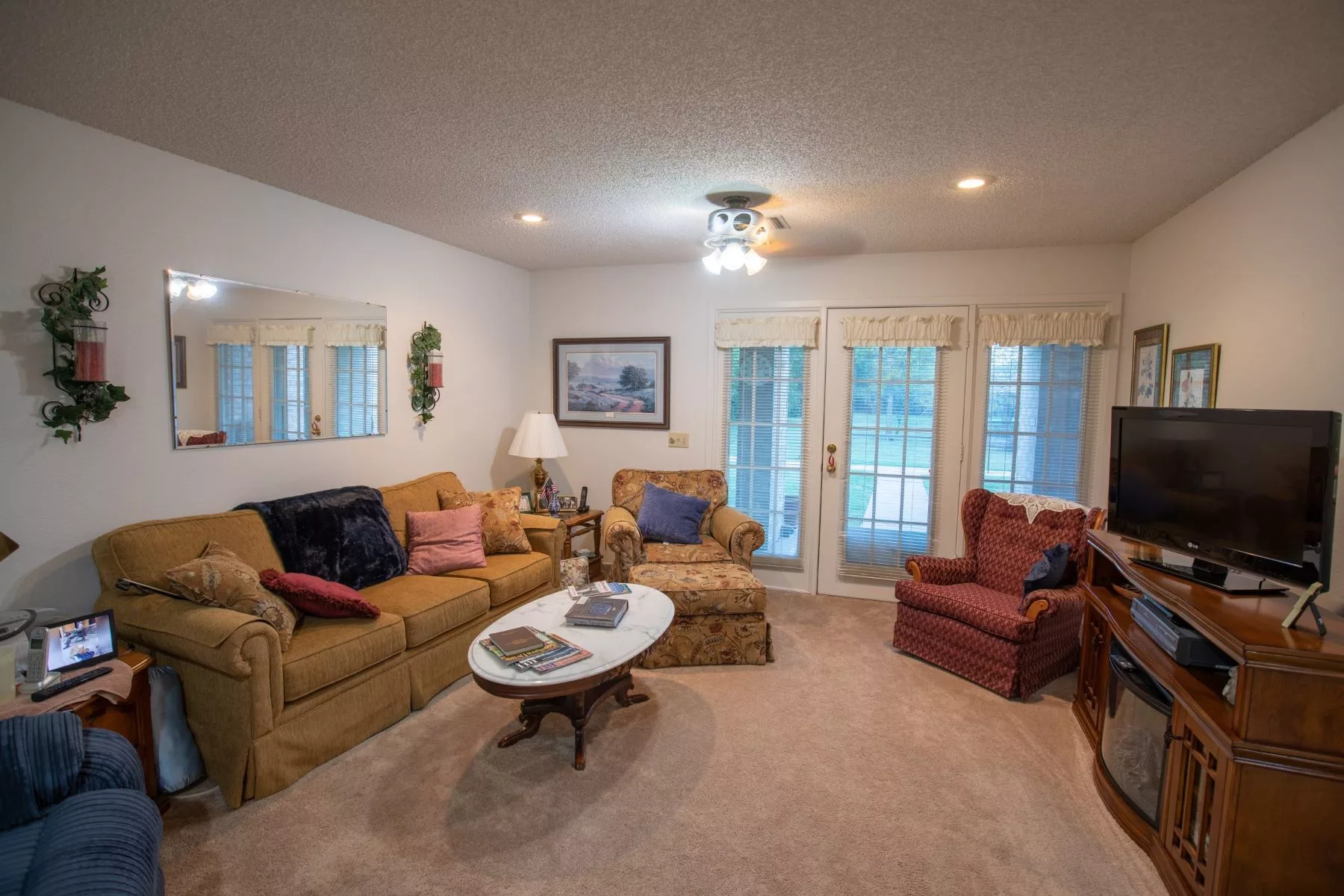 A cozy living room featuring comfortable seating and warm lighting.