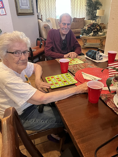 Two seniors enjoying a friendly game of bingo together.