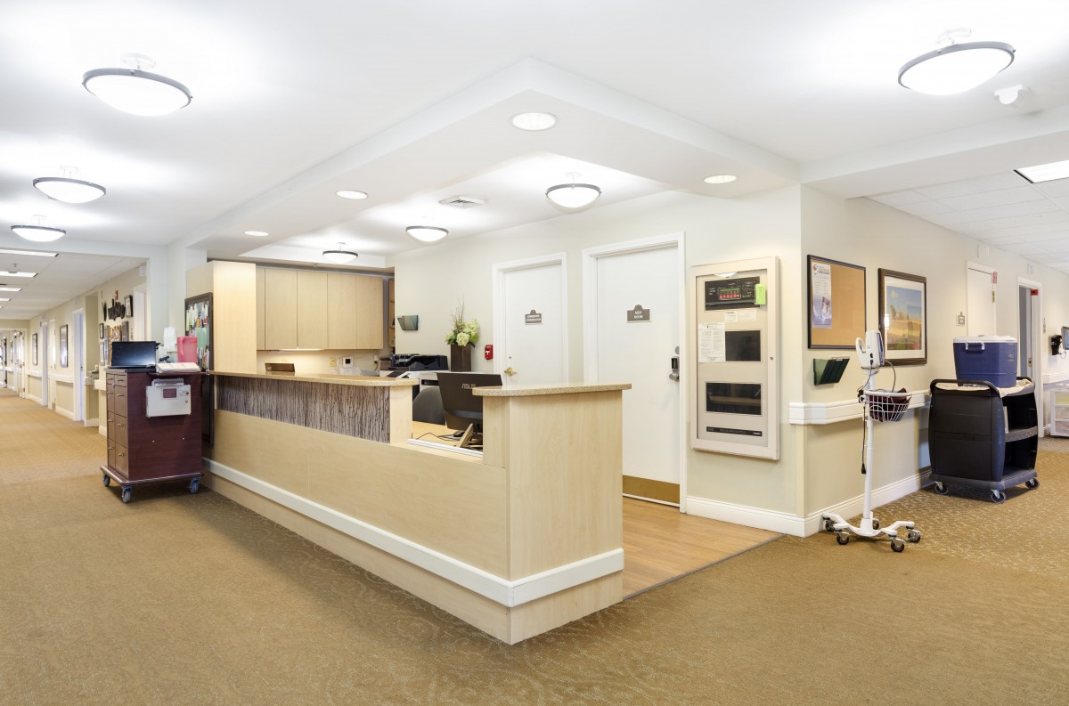 A modern and clean reception area with a desk and seating.