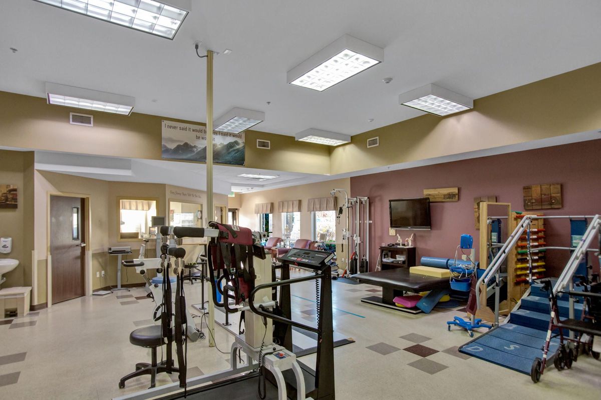 A spacious gym equipped with various exercise machines and fitness equipment.