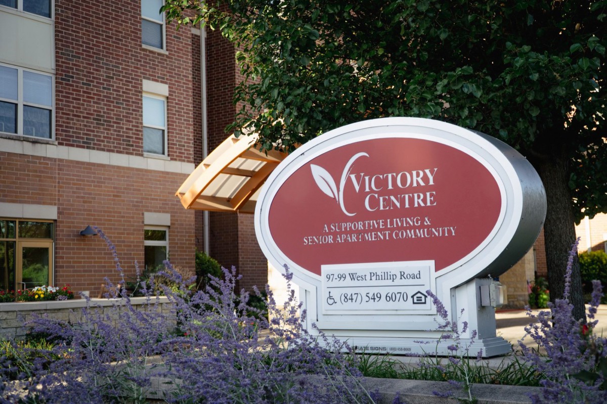 The Victory Centre building with its prominent sign for senior and assisted living services.