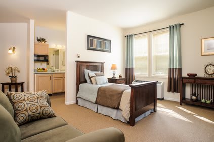 A cozy bedroom with a single bed and natural light.