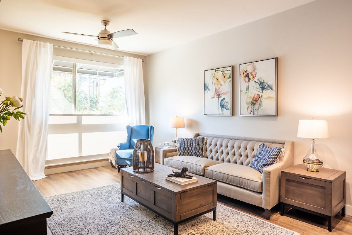 A cozy living room with a sofa, armchair, and decorative elements.