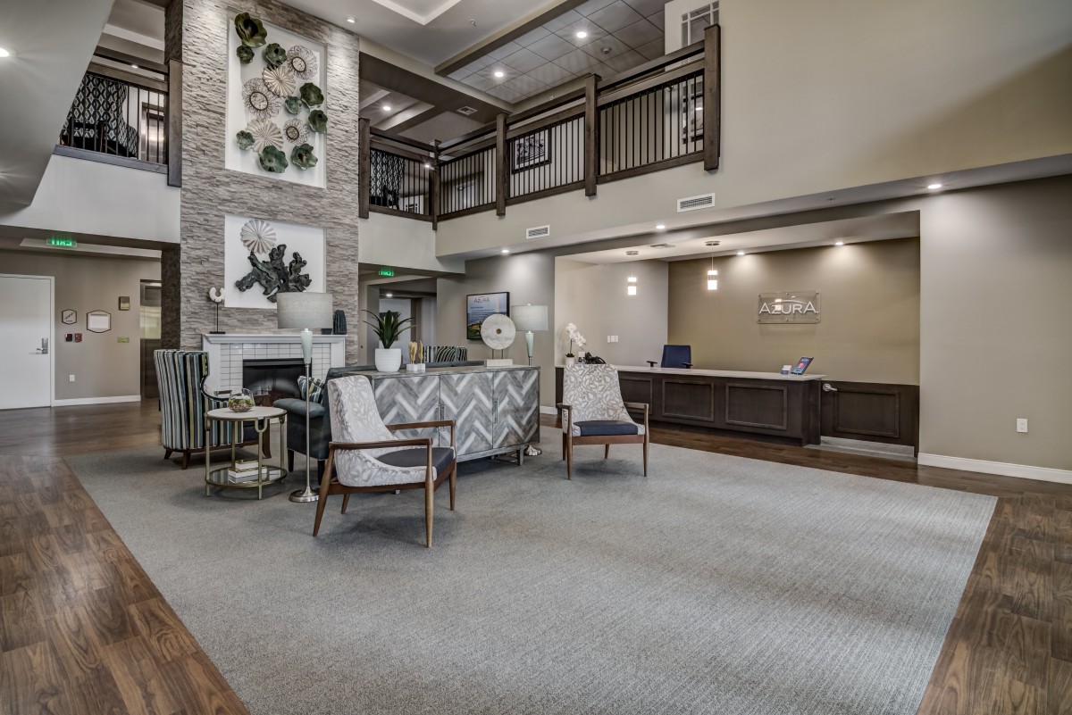 A modern lobby with seating area and a reception desk.